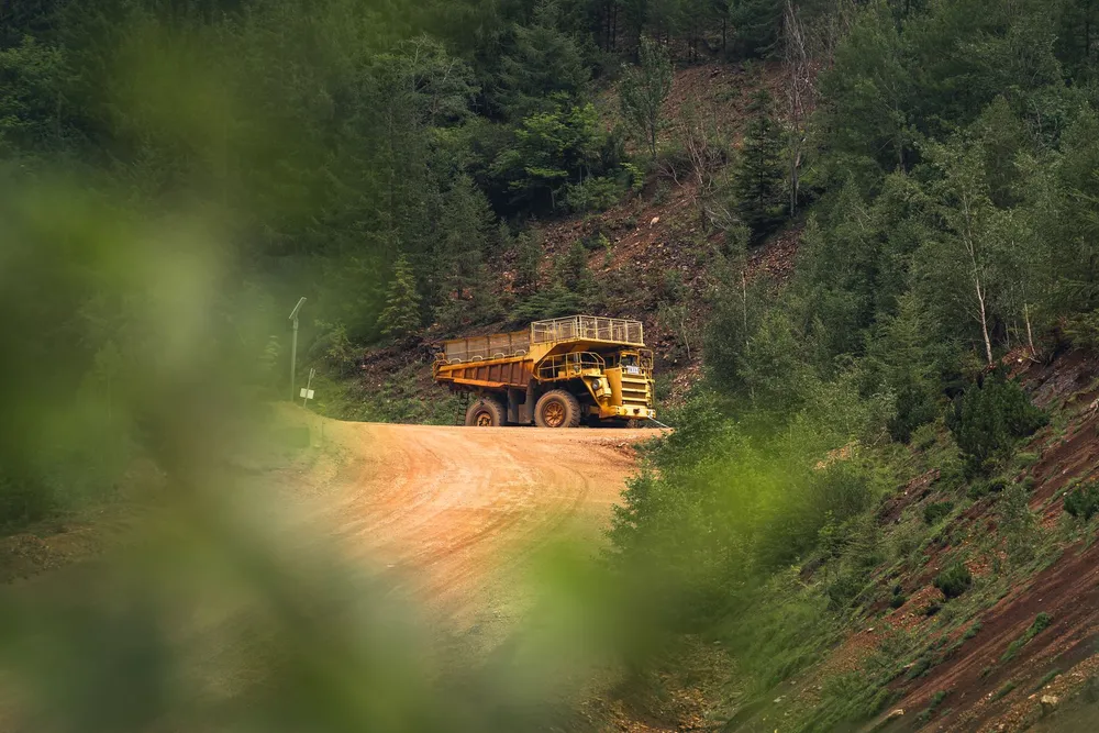 Loaded truck hauling bulk material down a road for delivery in the Norman, Oklahoma area