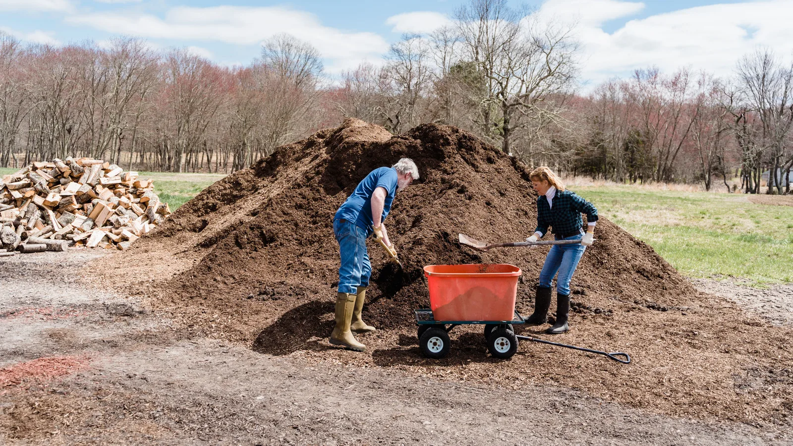 A large pile of bulk mulch delivered to a yard in the Oklahoma City metro, being moved with a garden cart