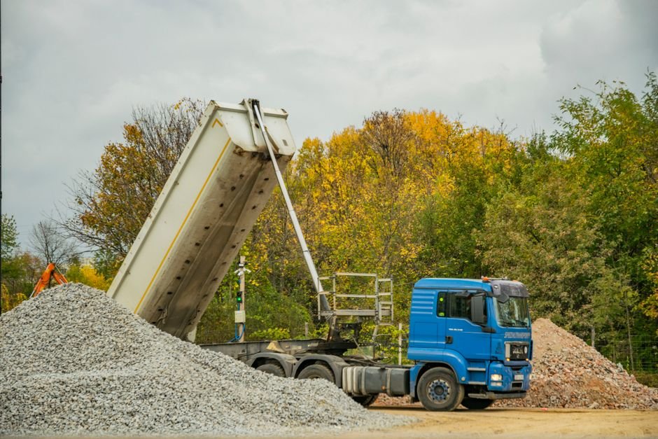 Dump truck unloading bulk landscape material at a job site in Oklahoma