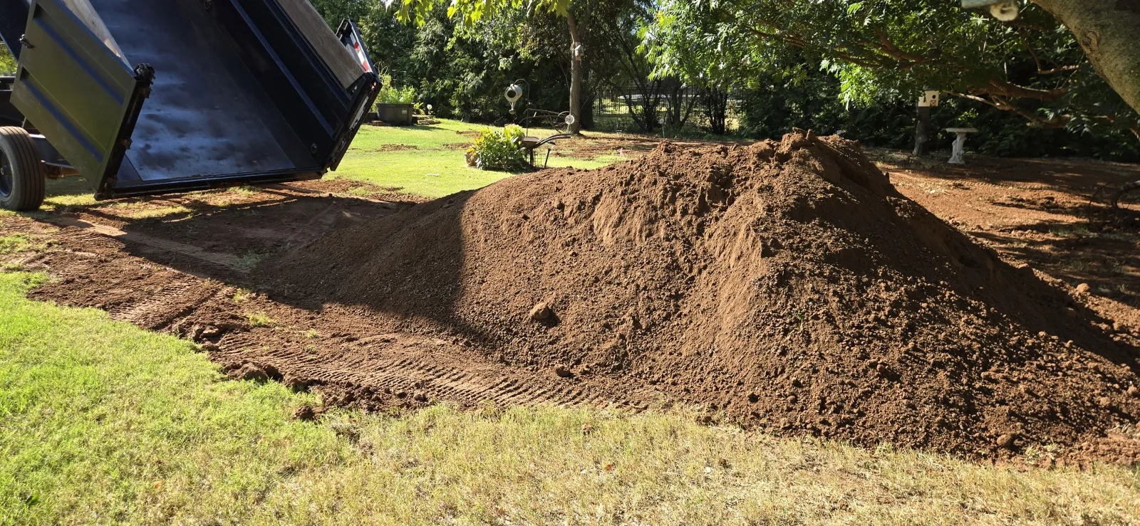 Seven cubic yards of screened topsoil delivered and dumped in a Norman, Oklahoma yard