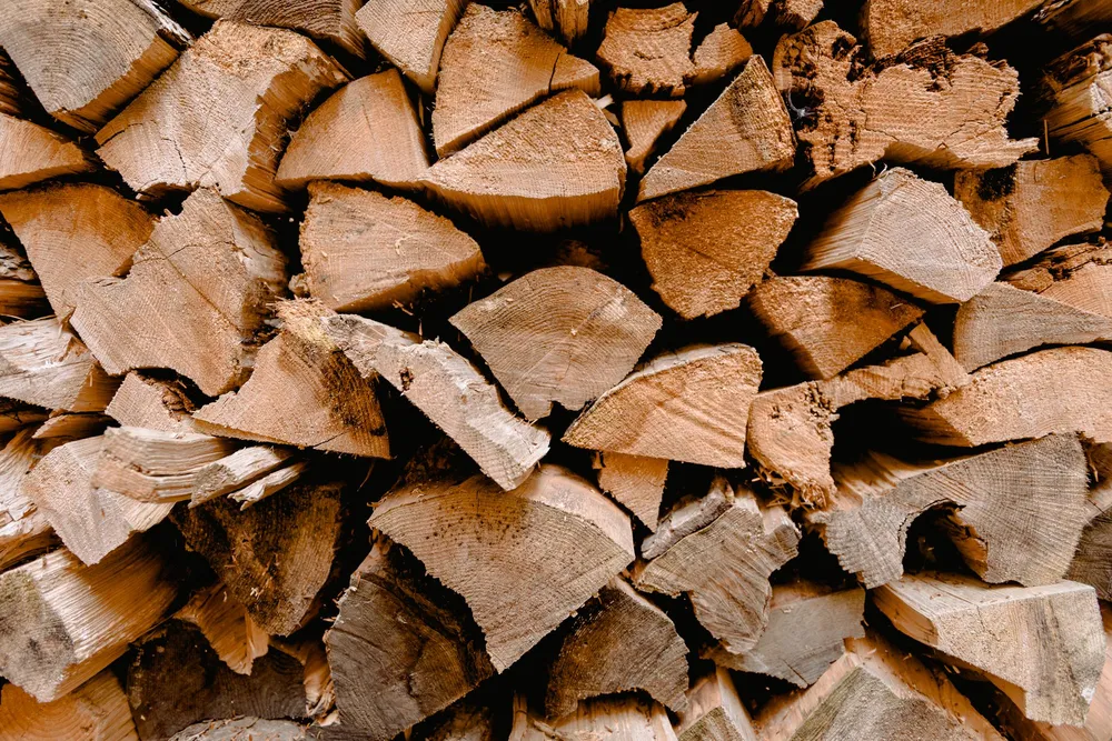 Neatly stacked seasoned hardwood firewood, cut and split for sale in Norman, Oklahoma