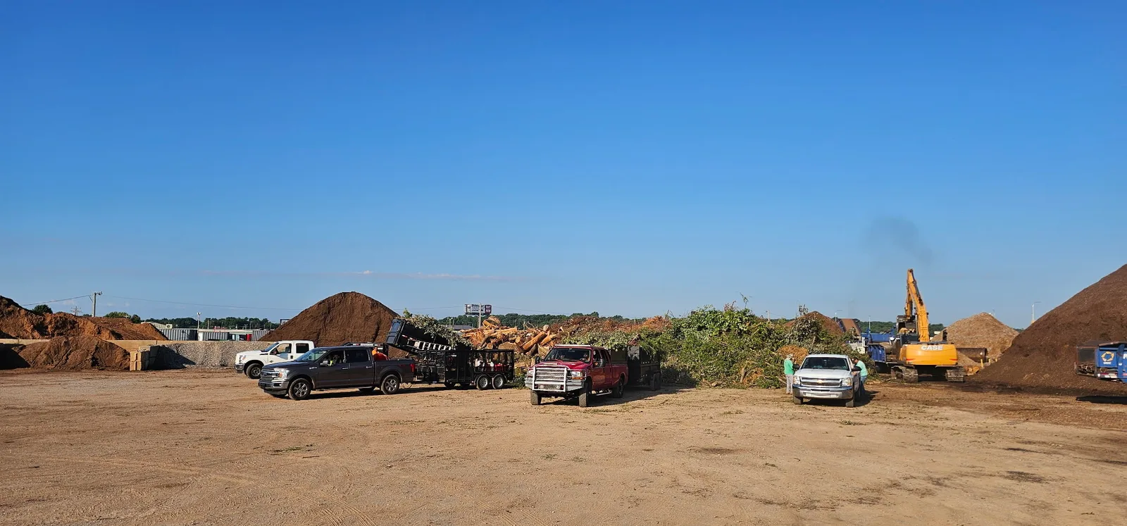 Customer pickup trucks and trailers being loaded at the Riverside Wood landscape yard in Norman, OK